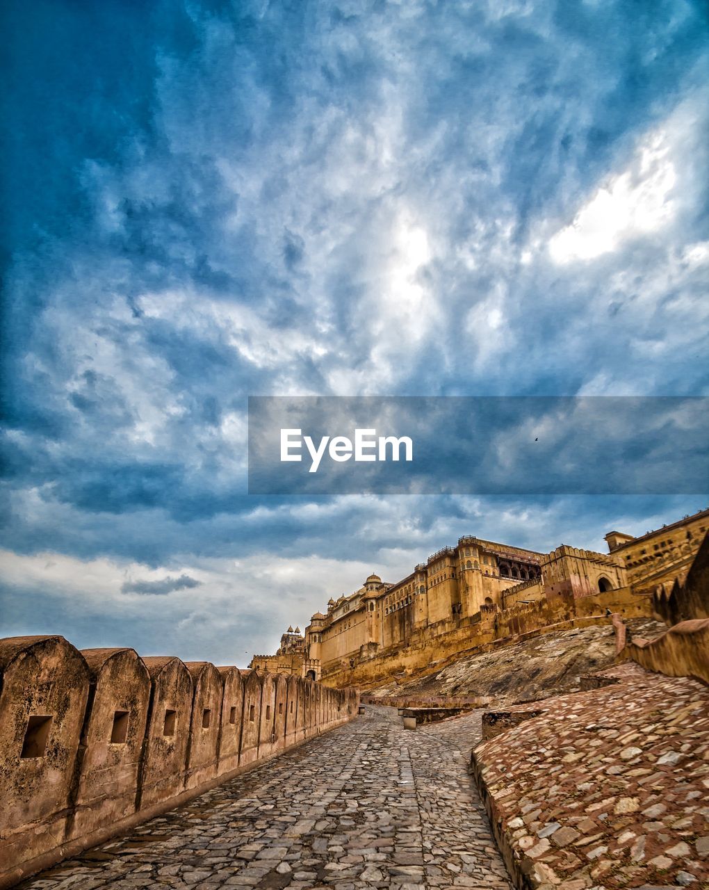 Ruins of building against cloudy sky