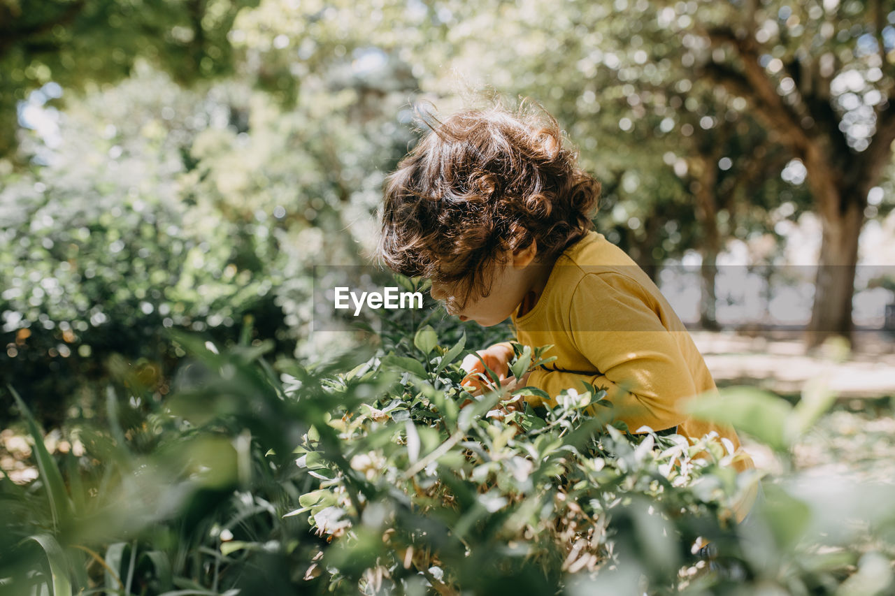 Side view of woman on flowering plants