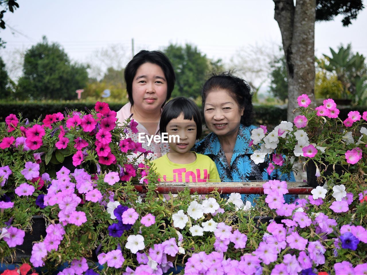 Portrait of family against blooming flowers