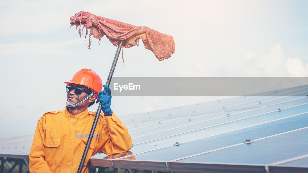 Manual worker cleaning solar panels