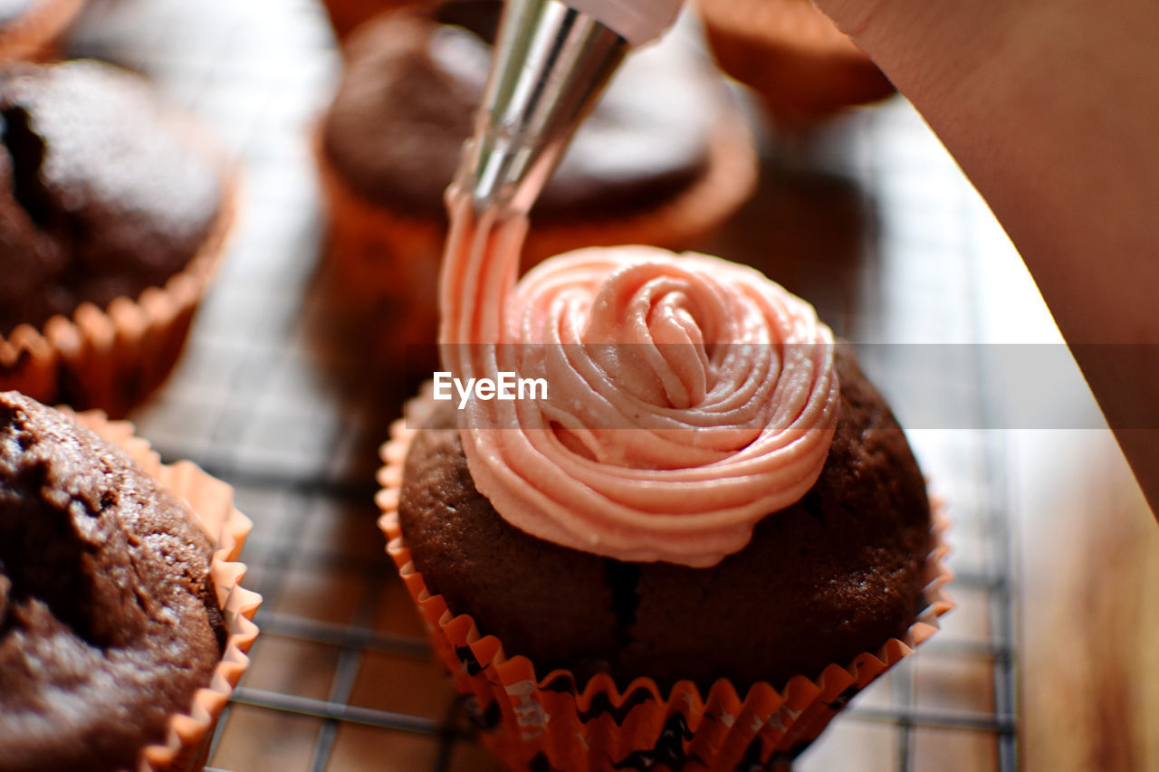 Decorating a cupcake with icing
