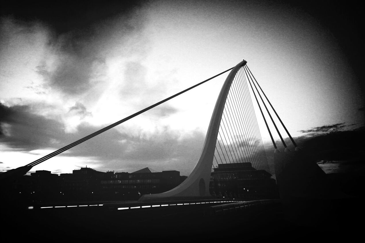 LOW ANGLE VIEW OF BRIDGE OVER RIVER