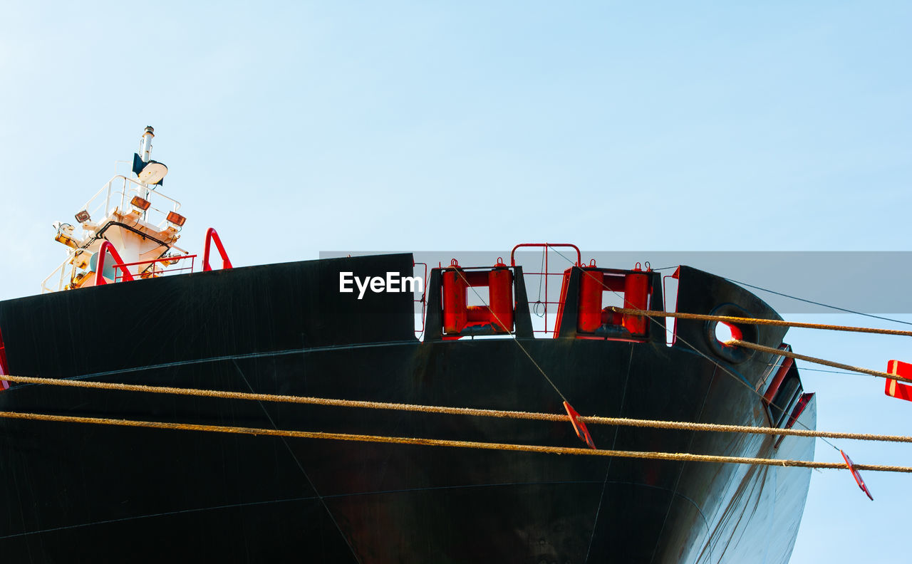 LOW ANGLE VIEW OF RED BOAT AGAINST SKY