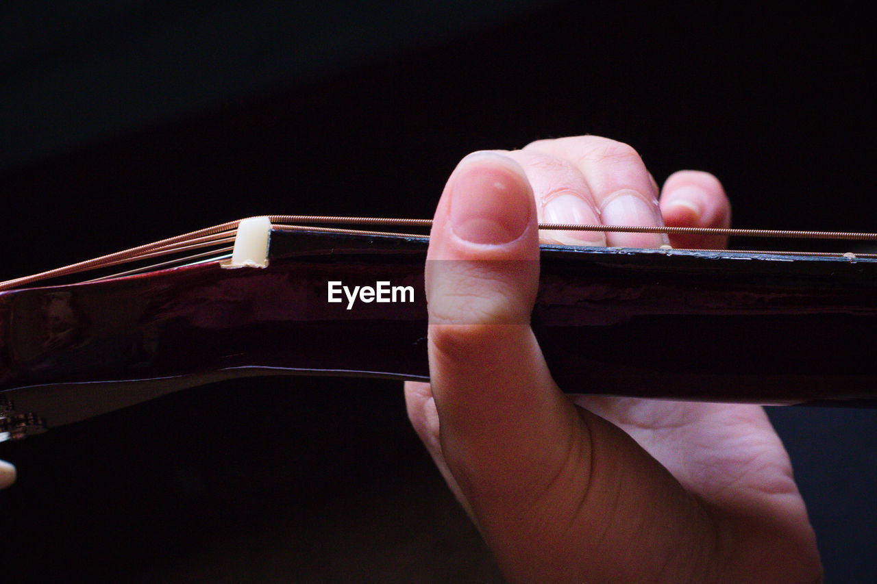 Close-up of person playing guitar