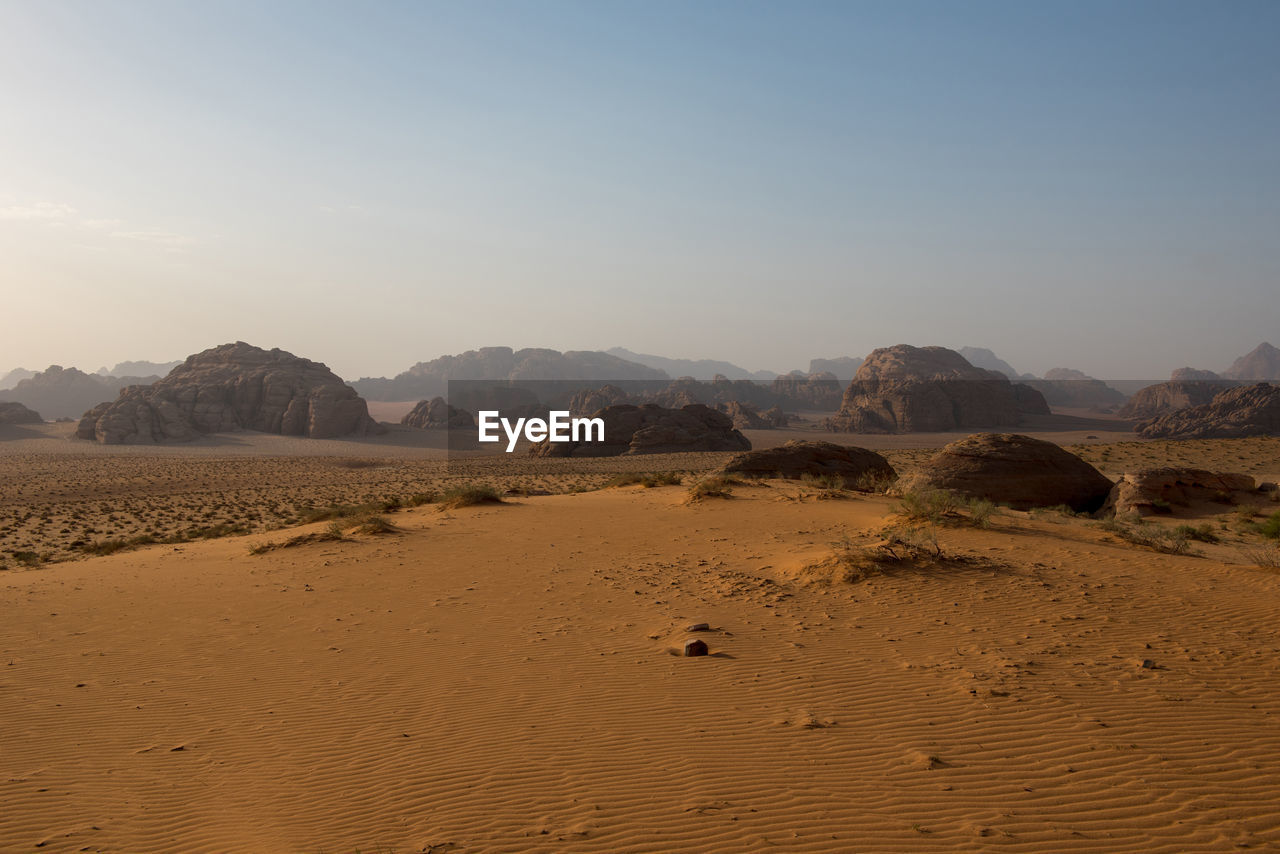 Sand dunes and sandstone cliffs in wadi rum desert , jordan