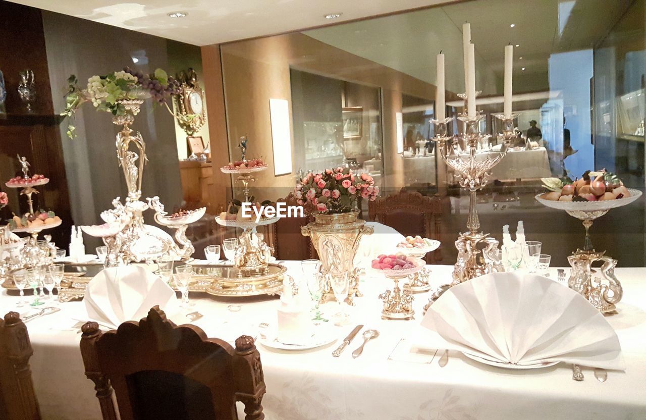 TABLE AND CHAIRS BY WINDOW IN ILLUMINATED ROOM