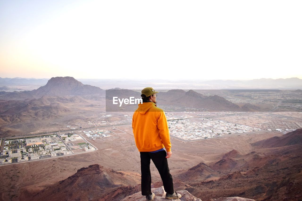 Rear view of man standing on mountain