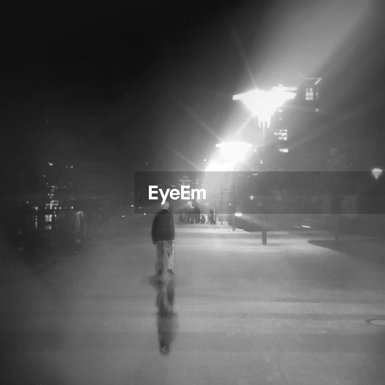 FULL LENGTH OF WOMAN WALKING ON ROAD AT NIGHT