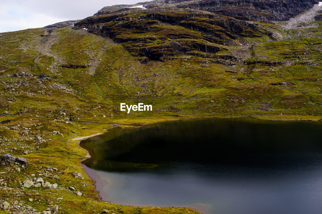 Scenic view of lake by mountain at hordaland