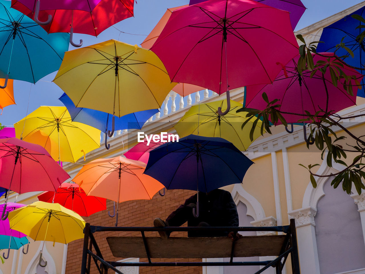 MULTI COLORED UMBRELLA ON RAINY DAY