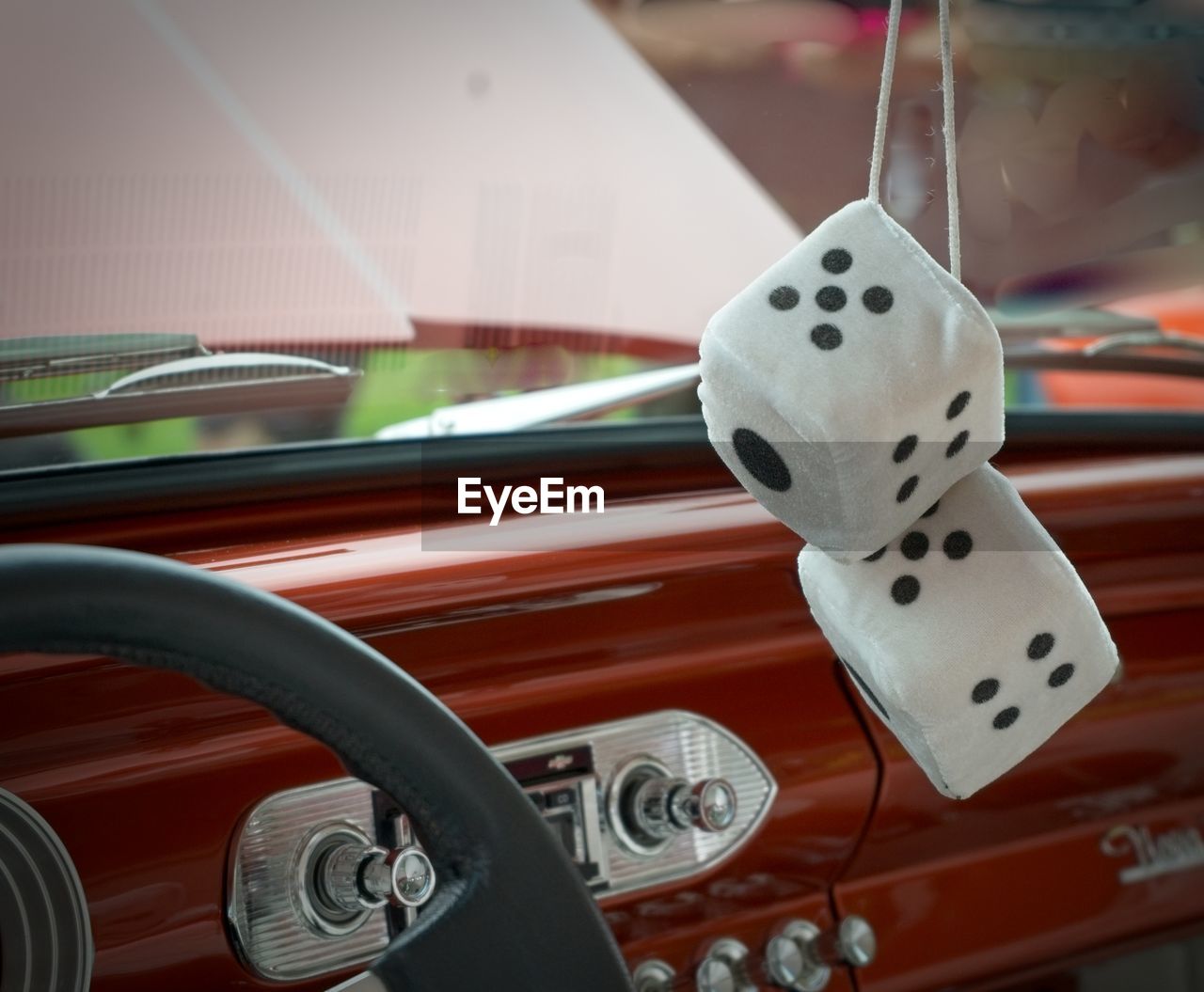 Close-up of dice hanging in car