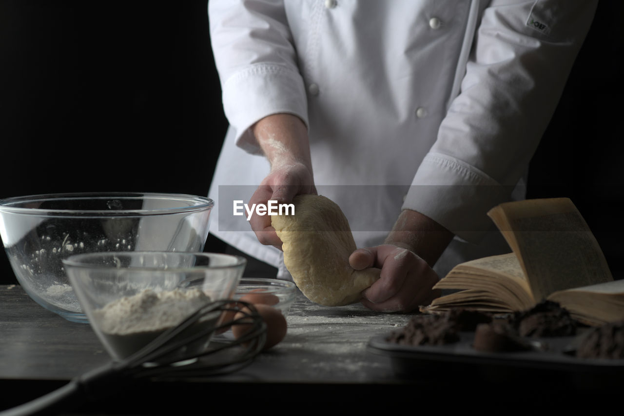 Midsection of chef preparing food at table