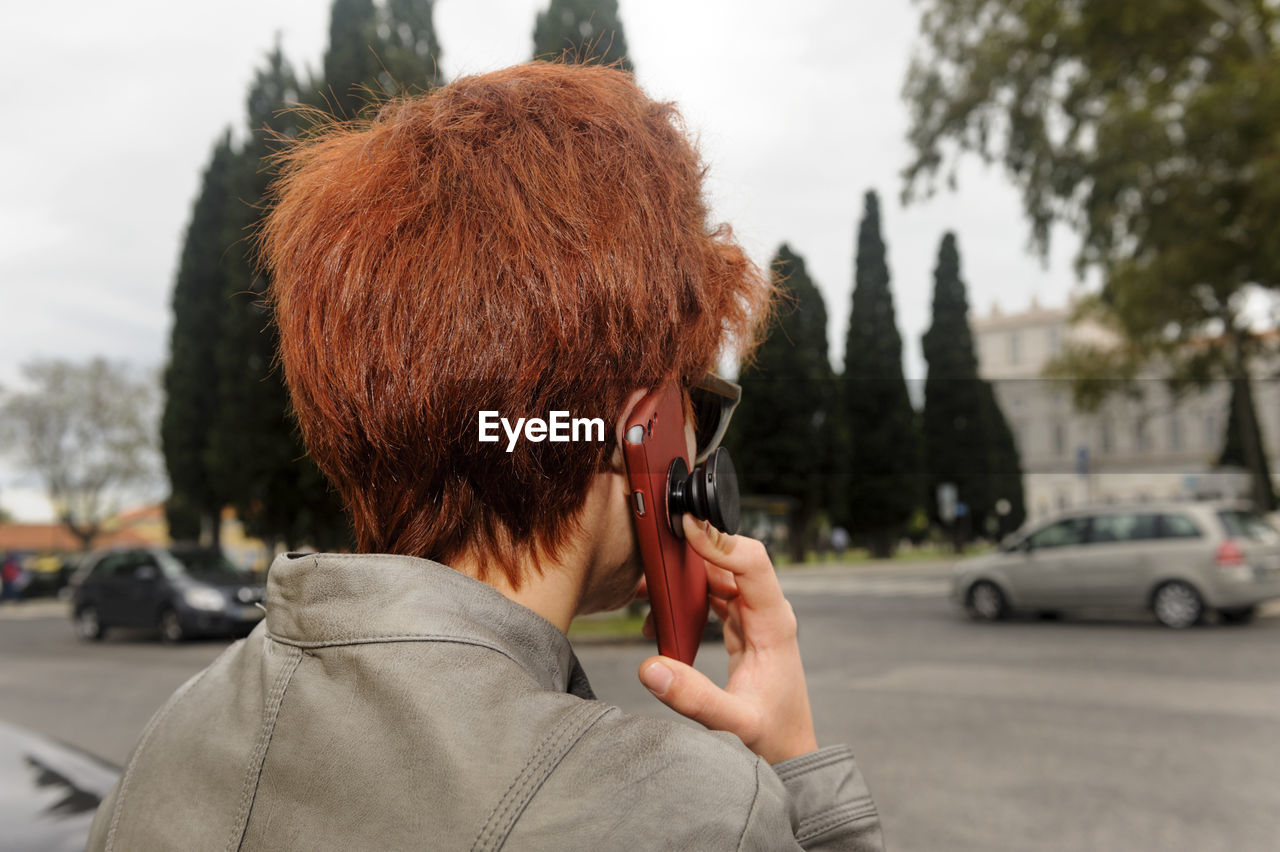 Woman talking on mobile phone in city