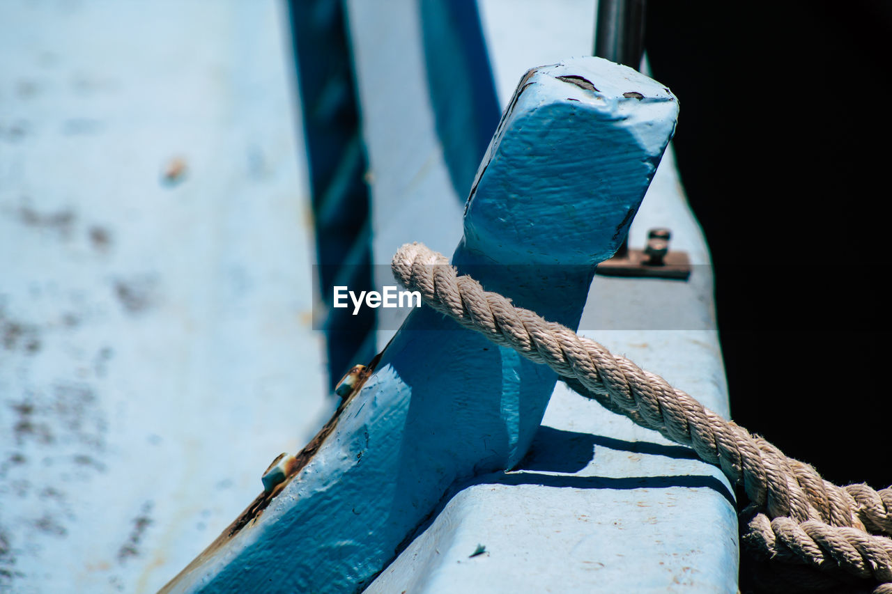 CLOSE-UP OF ROPE TIED UP ON BOAT