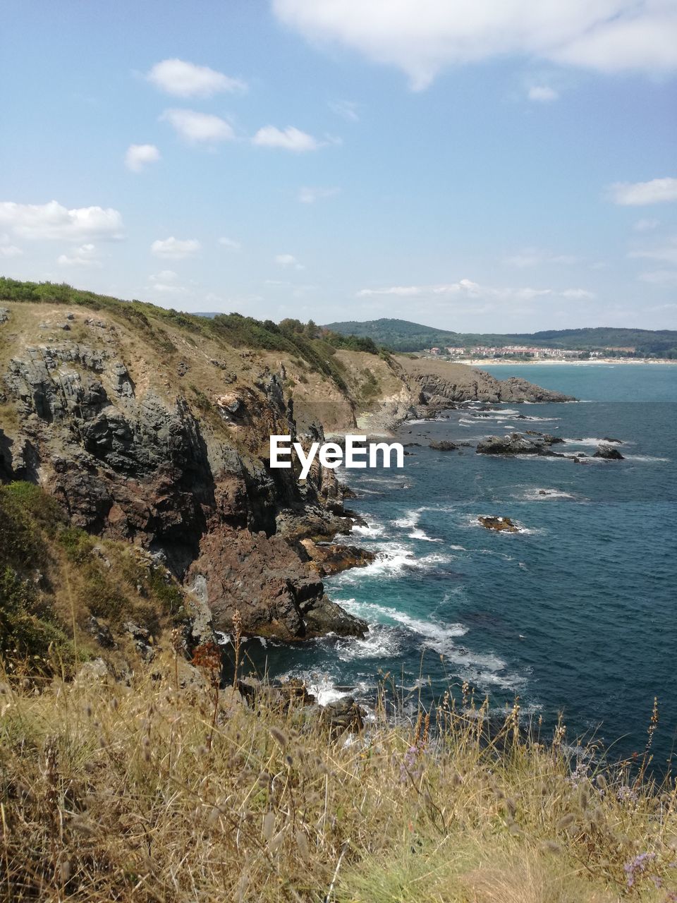 Scenic view of sea and mountains against sky