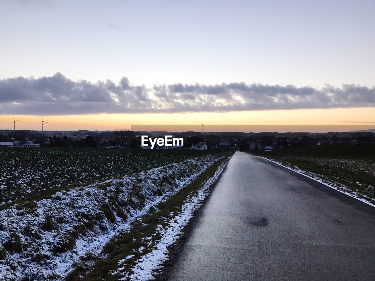 VIEW OF SNOWY LANDSCAPE DURING SUNSET