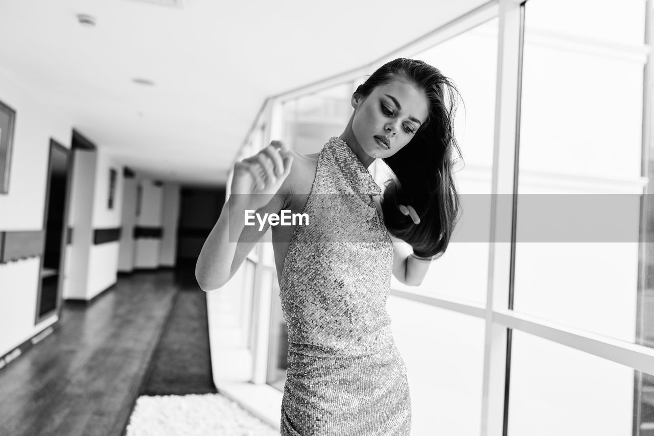 portrait of young woman standing on railing