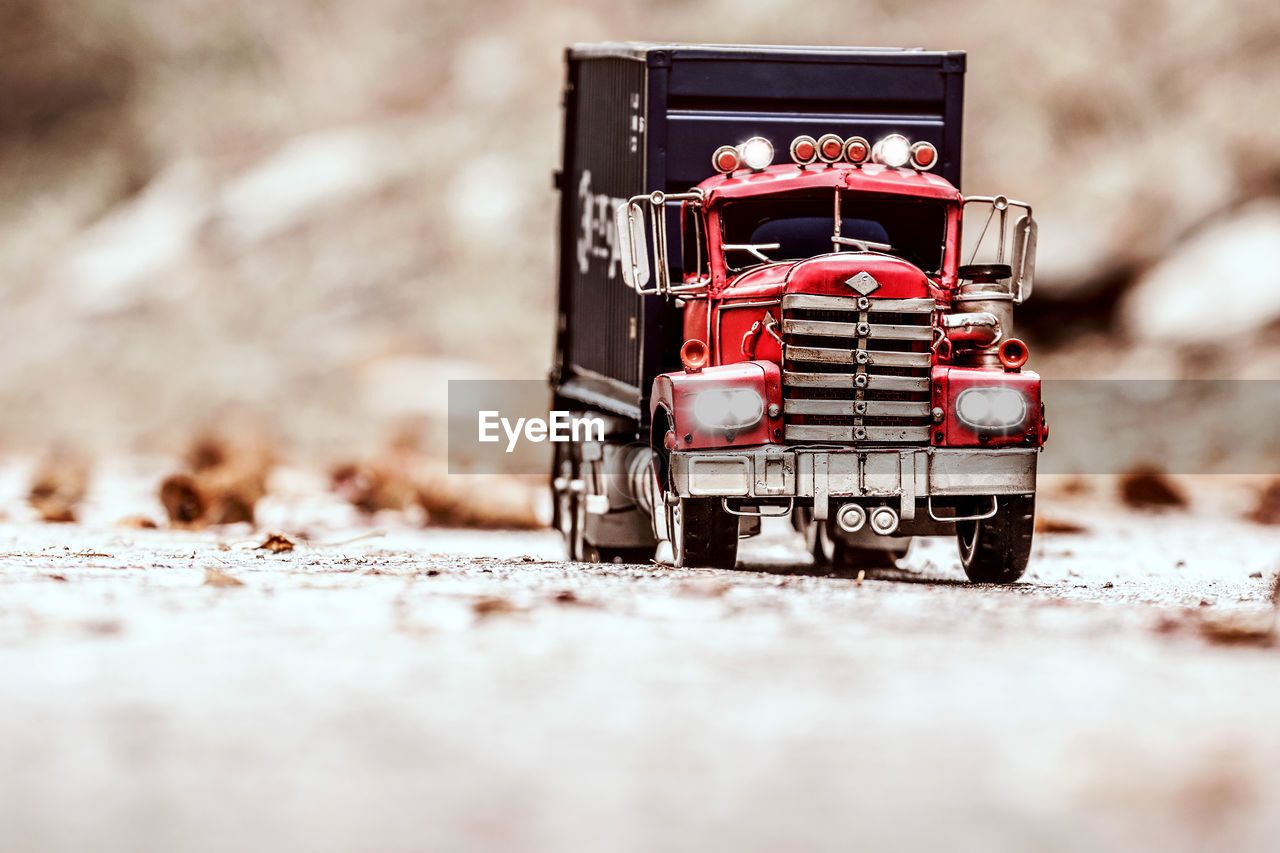 RED TOY CAR ON ROAD