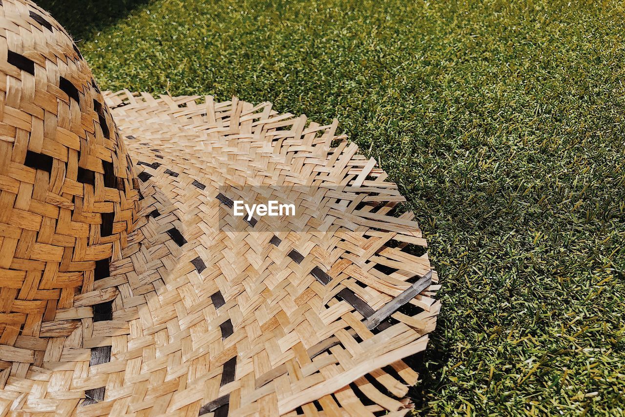 High angle view of straw hat on grass