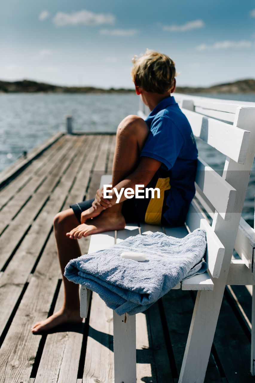 WOMAN SITTING ON BEACH