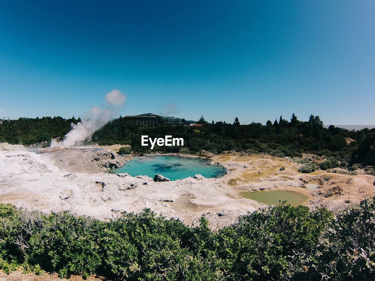 Scenic view of lake with hot springs against clear sky