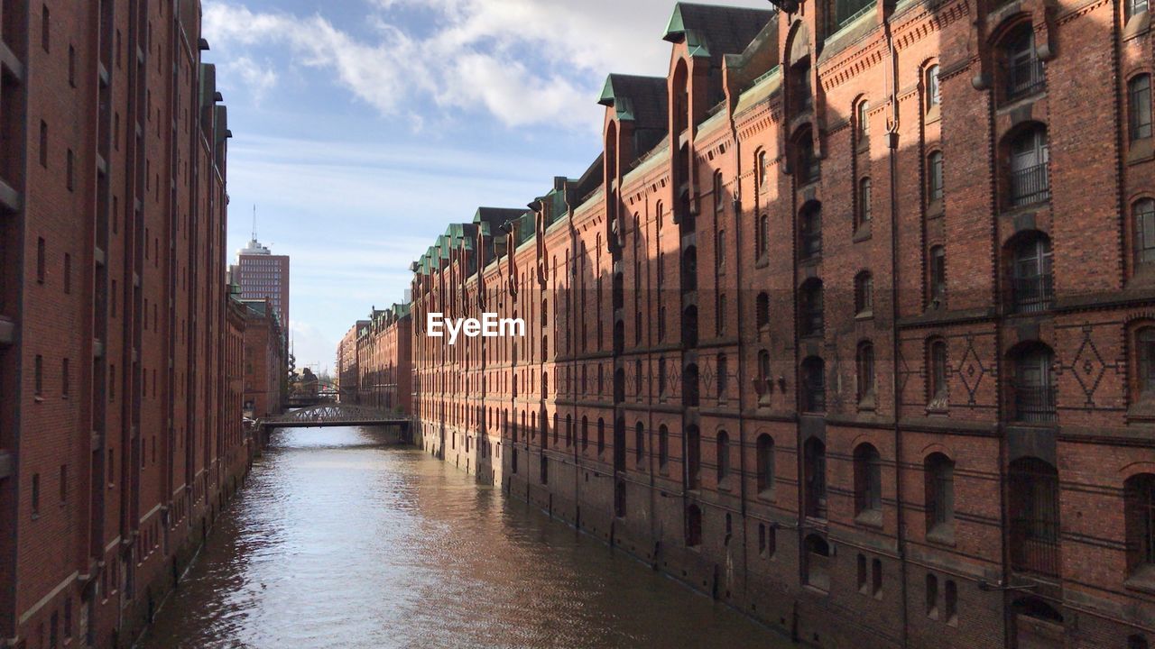 CANAL AMIDST BUILDINGS IN CITY