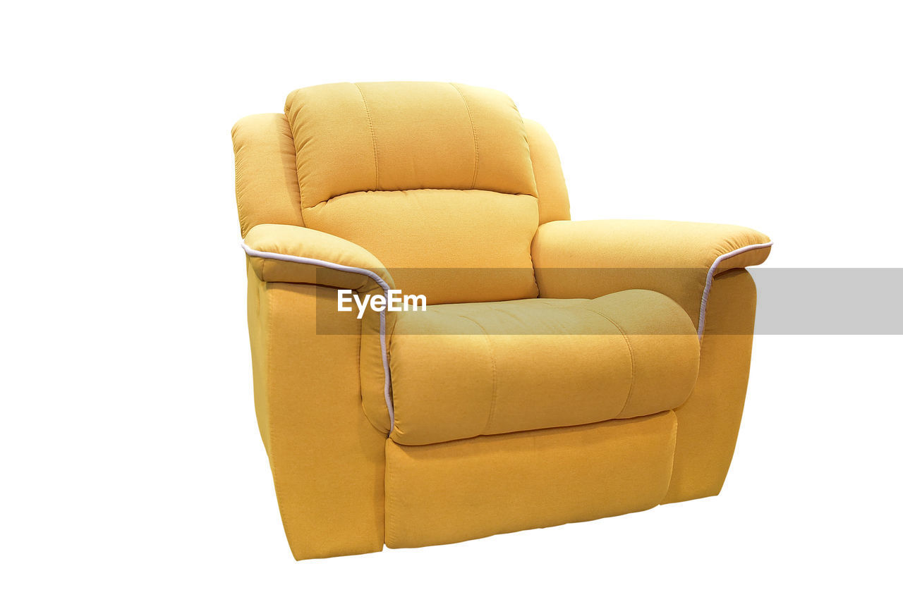 Close-up of empty armchair against white background
