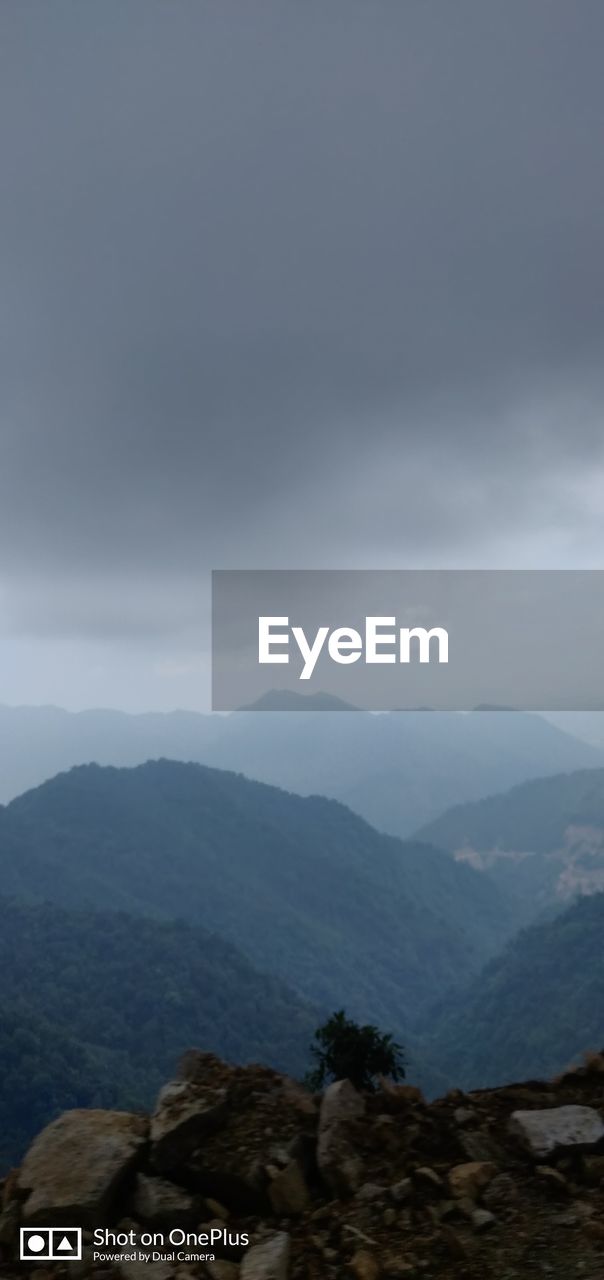 AERIAL VIEW OF MOUNTAINS AGAINST SKY