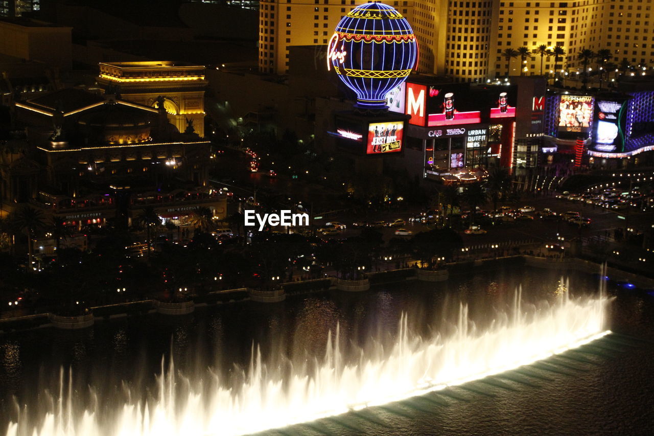 VIEW OF ILLUMINATED CITY AT NIGHT