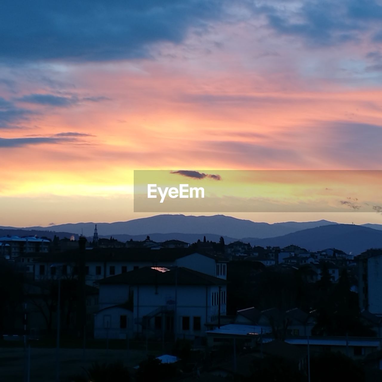 HOUSES AGAINST SKY DURING SUNSET