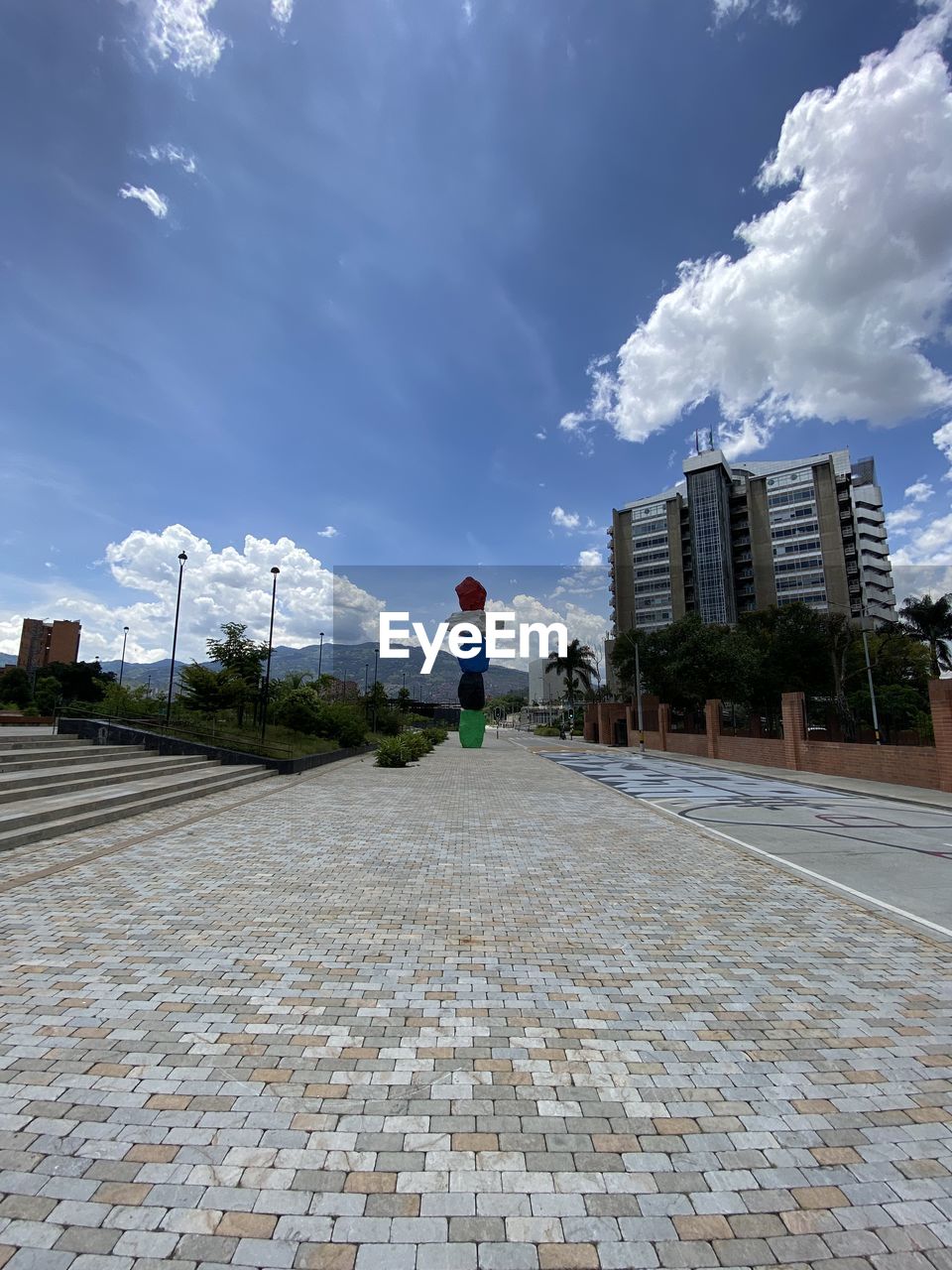 Stacked rock sculpture and edificio epm as seen from parques del río medellín