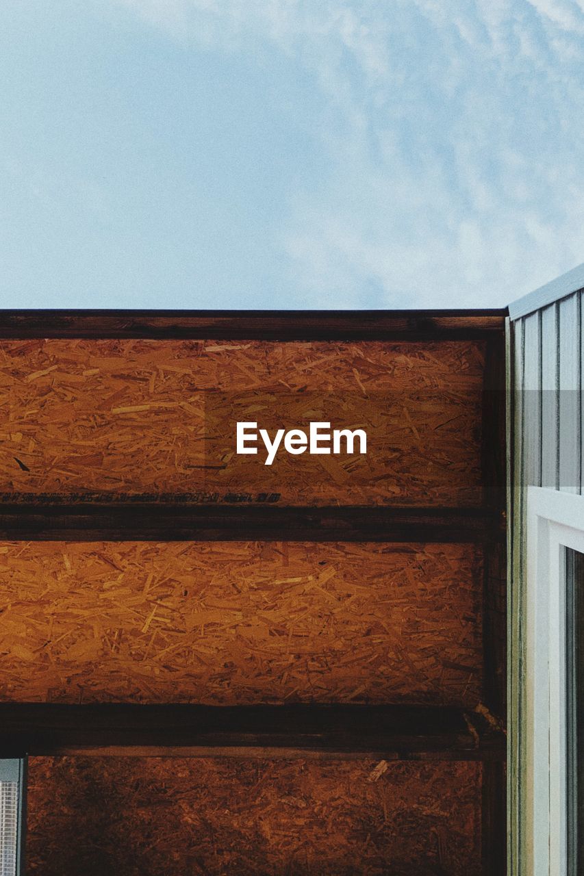 LOW ANGLE VIEW OF WOODEN WALL OF BUILDING