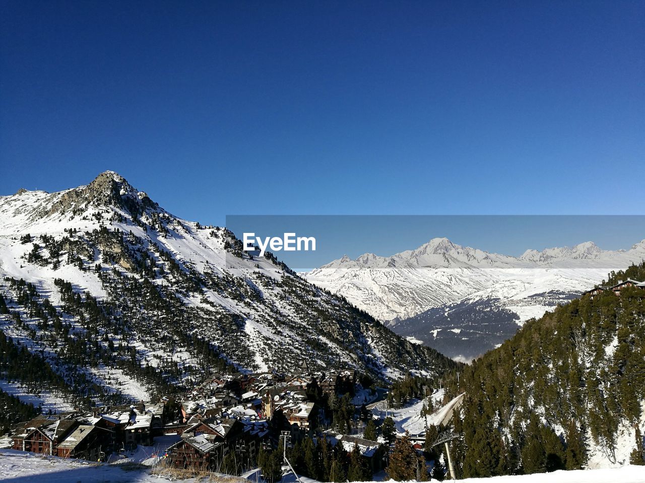 Low angle view of mountains against clear blue sky