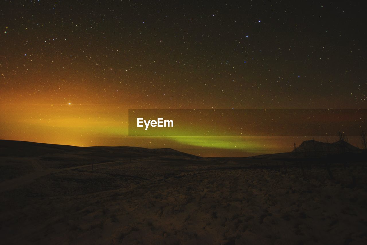 Scenic view of landscape against sky at night