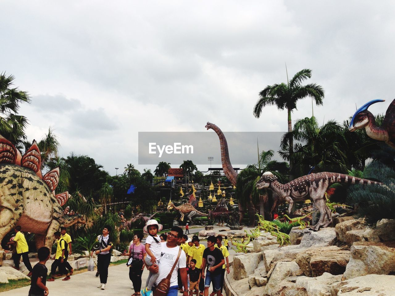 GROUP OF PEOPLE IN FRONT OF TREES