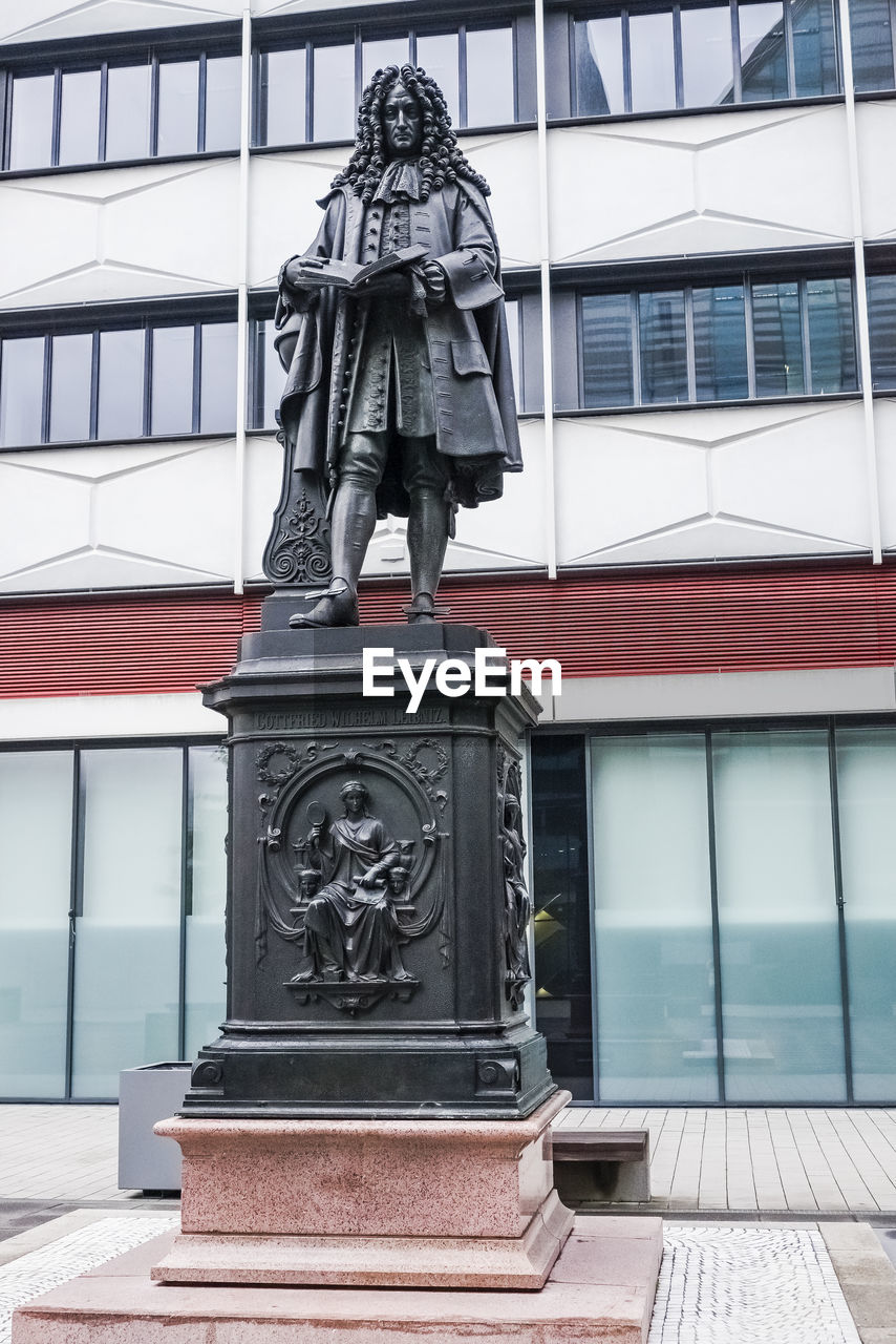 STATUE AGAINST BUILDINGS