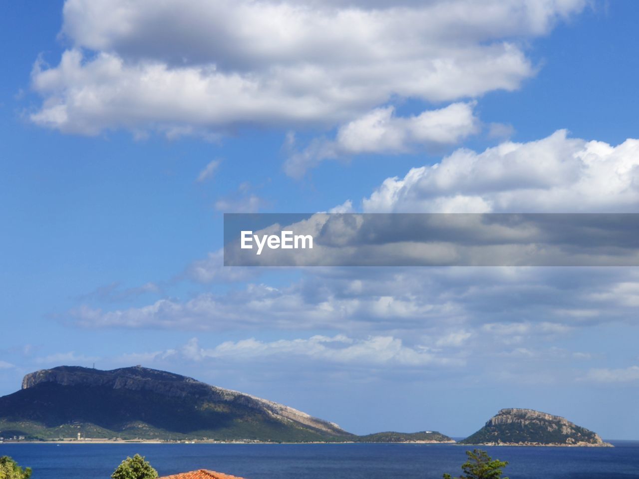 Scenic view of sea and mountains against sky