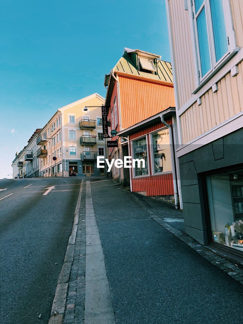 Empty street amidst buildings against sky