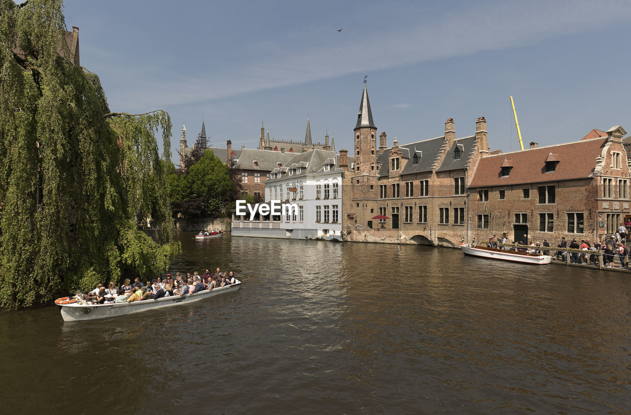 GROUP OF PEOPLE ON BOAT IN RIVER