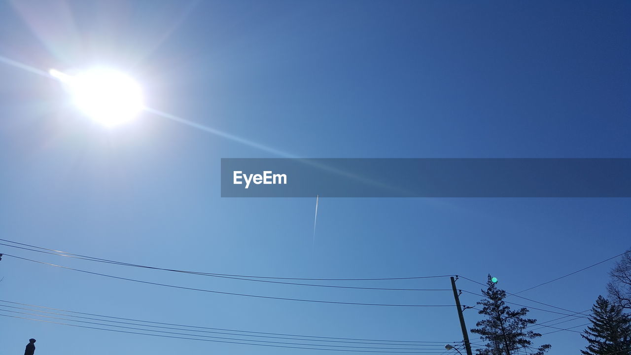 LOW ANGLE VIEW OF VAPOR TRAILS IN SKY