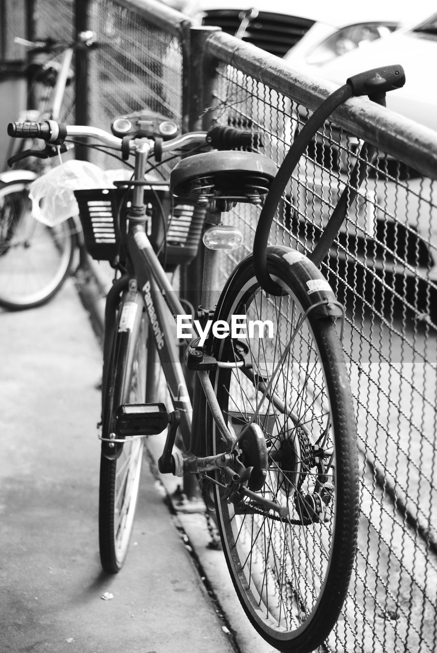 CLOSE-UP OF BICYCLE ON RAILING