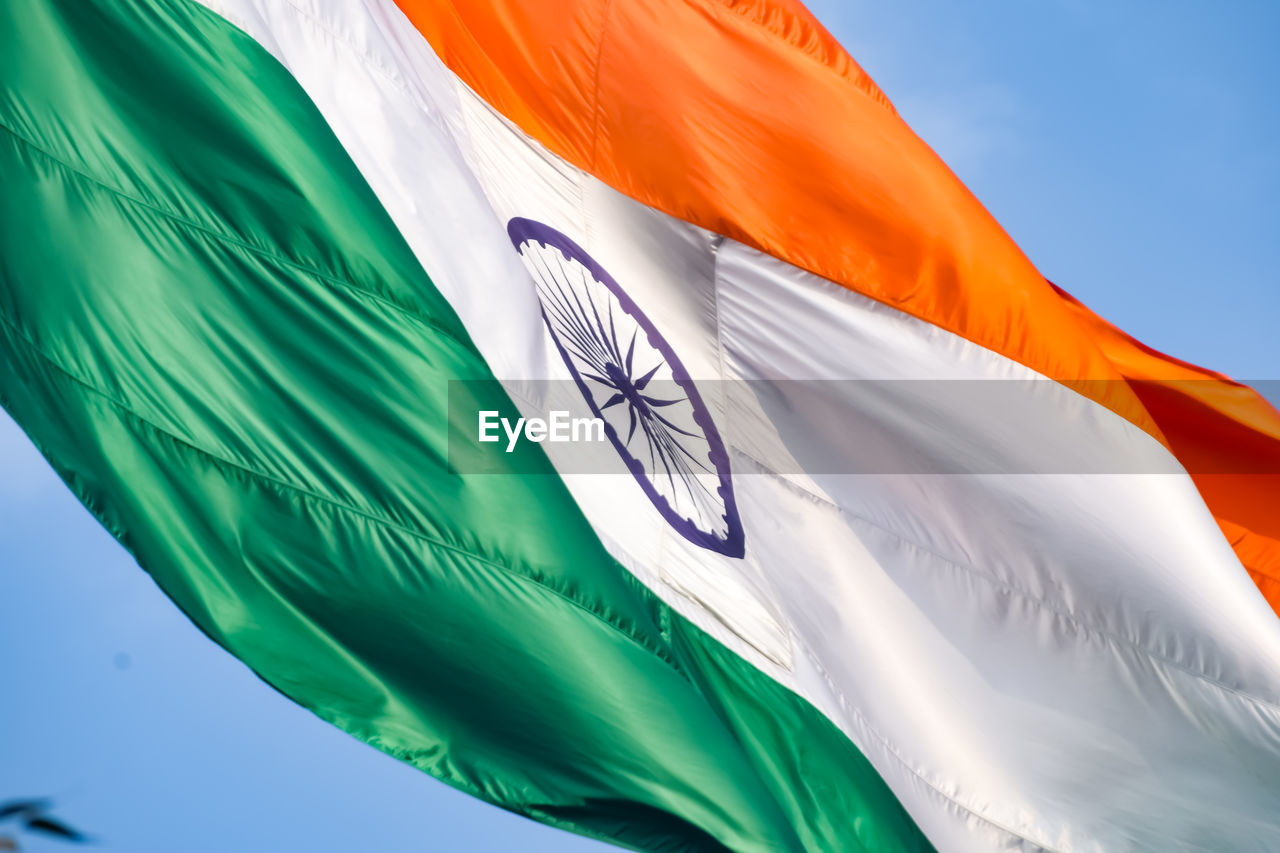 flag, wind, environment, nature, blue, textile, no people, patriotism, green, multi colored, low angle view, sky, outdoors, wing, day, white