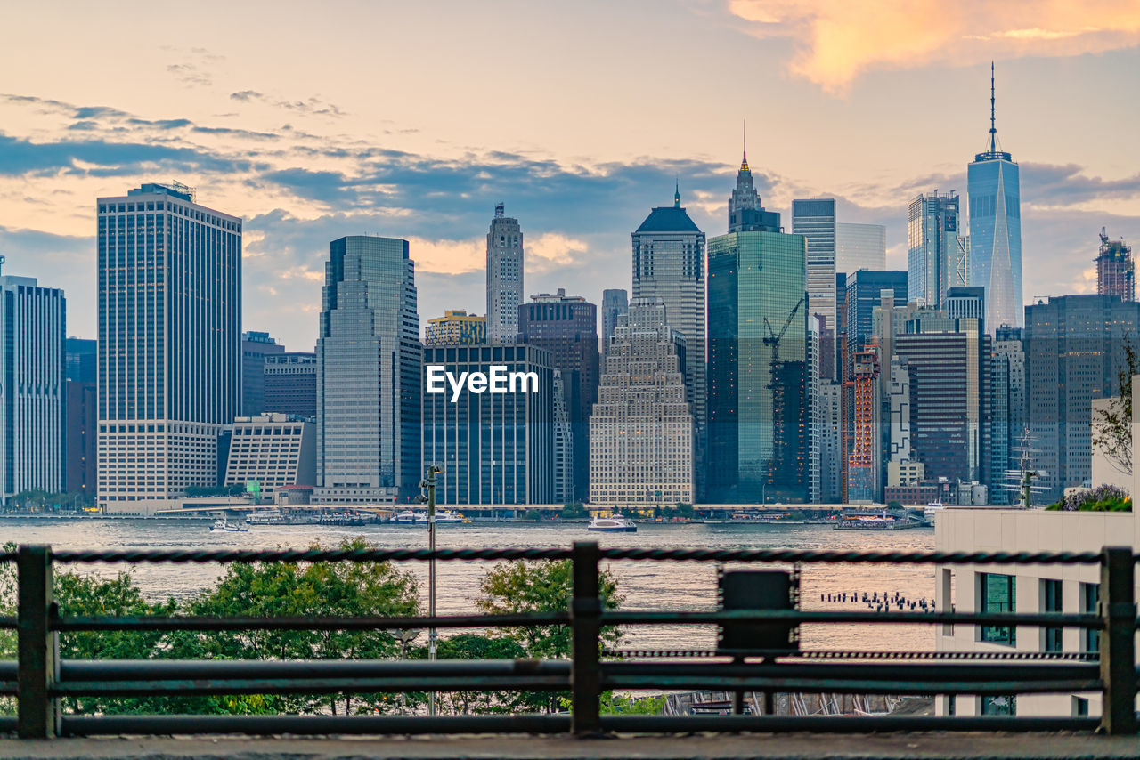 Buildings in city against sky during sunset