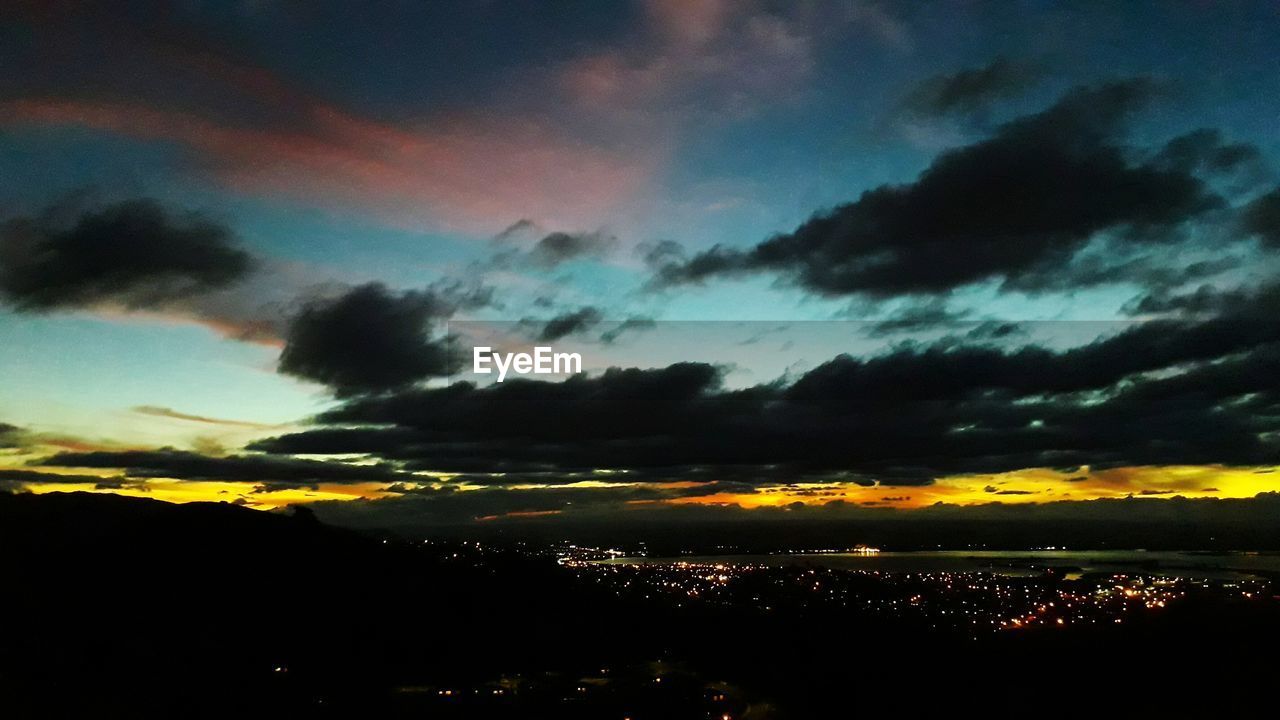 DRAMATIC SKY OVER CITY DURING SUNSET