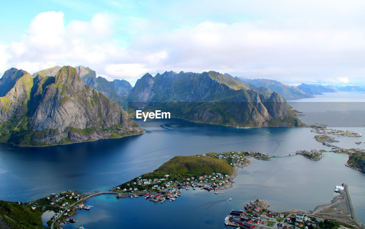 Scenic view of sea and mountains against sky from high altitude