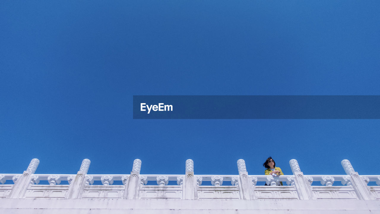 Low angle view of building against clear blue sky