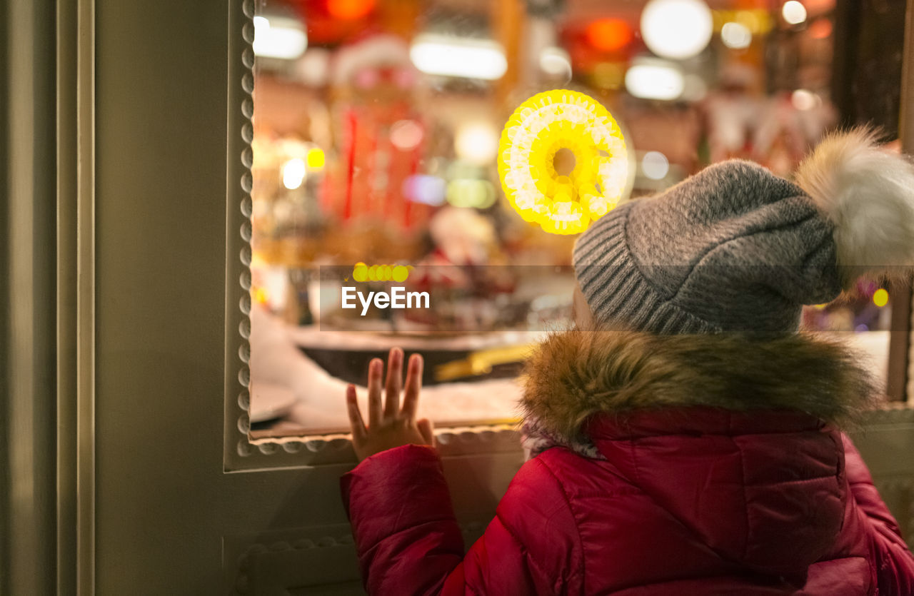 Girl looking at a christmas shop window