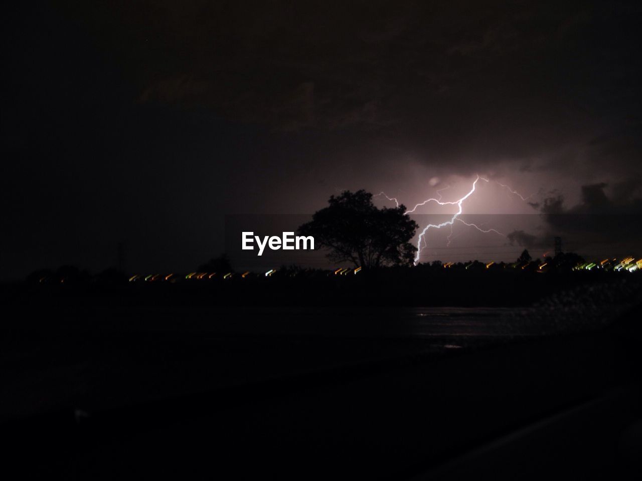 SCENIC VIEW OF LIGHTNING OVER SILHOUETTE TREES