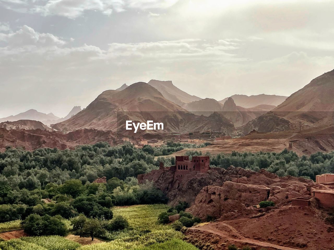 scenic view of mountains against cloudy sky