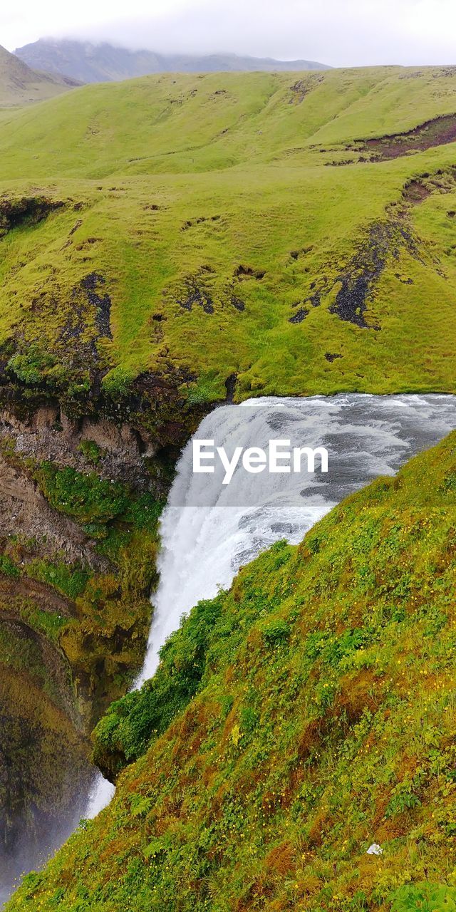 SCENIC VIEW OF RIVER FLOWING THROUGH MOUNTAINS